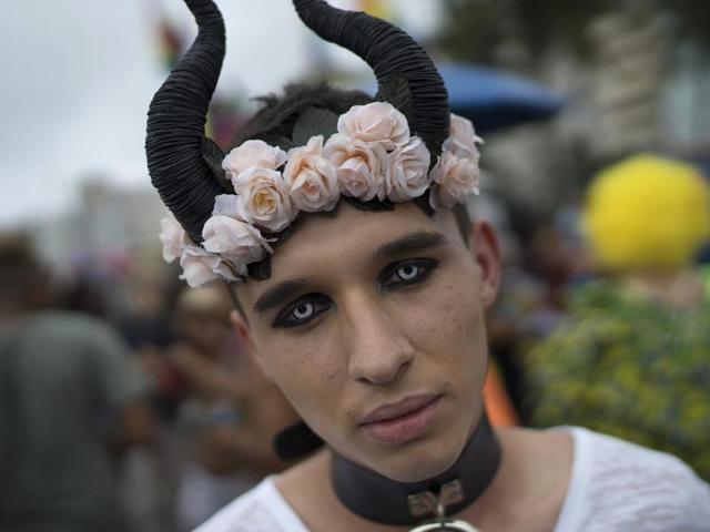 As many as a million people participated in the parade to fight for more justice and inclusive society which recognizes equal rights for the gay community. A man wearing special contact lenses poses for during the parade. (AP)