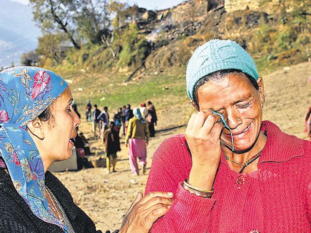 Inconsolable women in Kullu after their houses were gutted in a fire at Kotla village on Sunday. (PTI) Inconsolable women in Kullu after their houses were gutted in a fire at Kotla village on Sunday. (PTI)