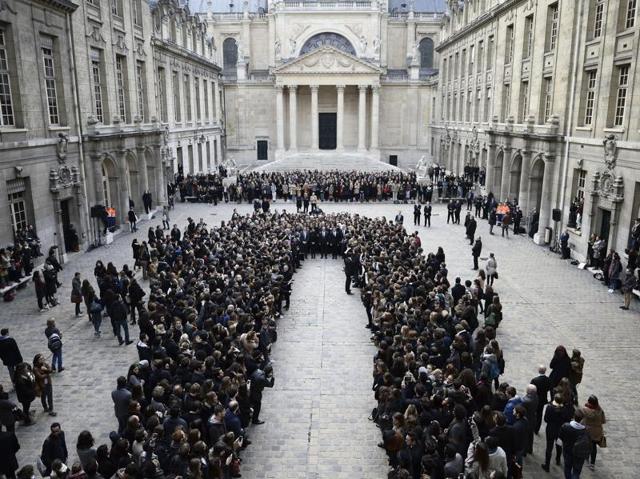 French President Francois Hollande, center, stands among students during a minute of silence in the courtyard of the Sorbonne University in Paris. (AP Photo) French President Francois Hollande, center, stands among students during a minute of silence in the courtyard of the Sorbonne University in Paris. (AP Photo)