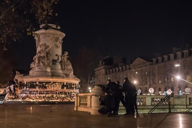 French police officers take position on Place de la Republique (Republic Square) after an alleged false alert sparked mass panic among a crowd on Sunday. (AP) French police officers take position on Place de la Republique (Republic Square) after an alleged false alert sparked mass panic among a crowd on Sunday. (AP)