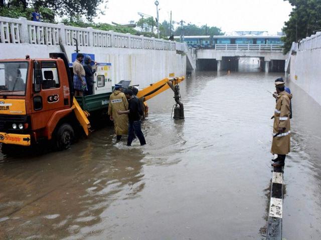 Corporation workers pumping out the rainwater from a waterlogged subway following heavy rains in Chennai. (PTI) Corporation workers pumping out the rainwater from a waterlogged subway following heavy rains in Chennai. (PTI)