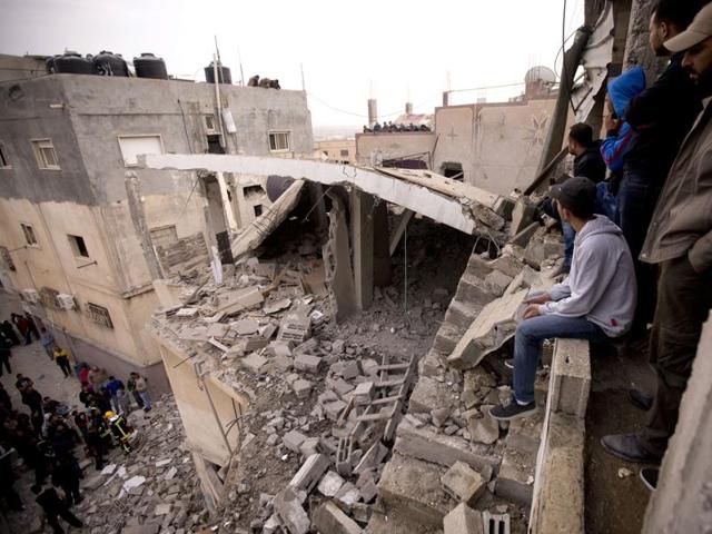 Palestinians look at a house that was demolished by the Israeli army, in the Qalandia refugee camp on the outskirts of the West Bank city of Ramallah, Monday, Nov. 16, 2015. Two Palestinians were killed and three wounded in clashes with Israeli troops early Monday in a Palestinian refugee camp in the Jerusalem area, a Palestinian health official said. (AP) Palestinians look at a house that was demolished by the Israeli army, in the Qalandia refugee camp on the outskirts of the West Bank city of Ramallah, Monday, Nov. 16, 2015. Two Palestinians were killed and three wounded in clashes with Israeli troops early Monday in a Palestinian refugee camp in the Jerusalem area, a Palestinian health official said. (AP)