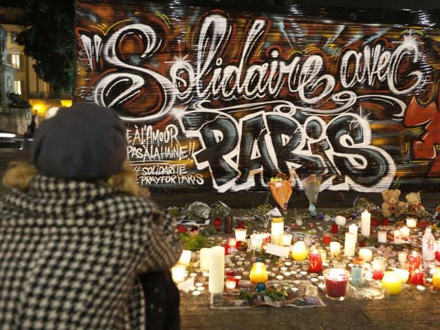 A woman sits in front of candles and flowers at a makeshift memorial in Nice, in tribute to November 13 attacks in Paris. (AFP Photo) A woman sits in front of candles and flowers at a makeshift memorial in Nice, in tribute to November 13 attacks in Paris. (AFP Photo)