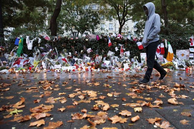 A man moves past floral tributes laid near the Bataclan Theater in Paris. (AFP) A man moves past floral tributes laid near the Bataclan Theater in Paris. (AFP)