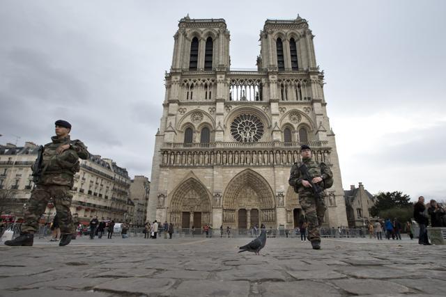 French soldiers patrol near Notre Dame cathedral in Paris. (AP) French soldiers patrol near Notre Dame cathedral in Paris. (AP)