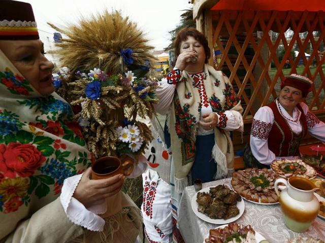 Women dressed in national clothes drink during the harvest festival in Dyatlovo, Belarus. (REUTERS)