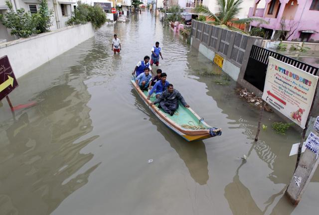 Rescue workers on a boat move people to safety at a residential area, in Chennai. (AP Photo)