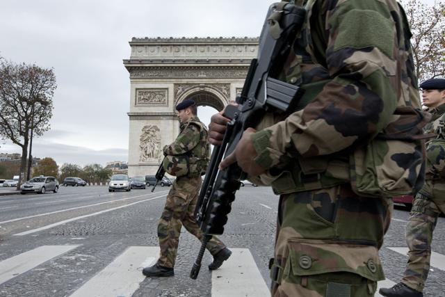 French soldiers cross the Champs Elysees avenue passing the Arc de Triomphe in Paris. (AP) French soldiers cross the Champs Elysees avenue passing the Arc de Triomphe in Paris. (AP)