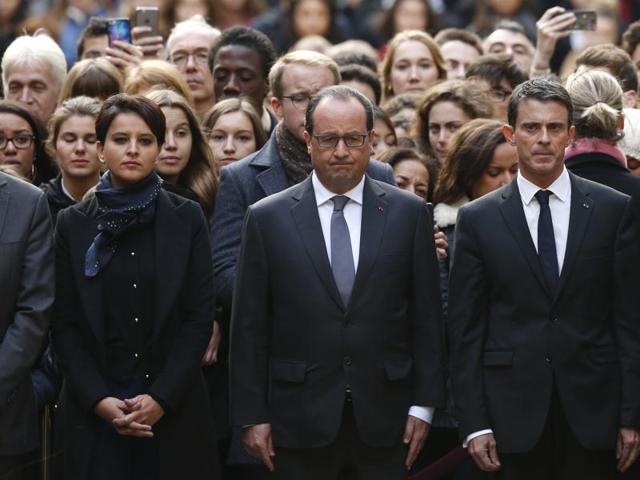 French President Francois Hollande, center, flanked by French Prime Minister Manuel Valls, right, and French education minister Najat Vallaud-Belkacem, center left, stands among students during a minute of silence in the courtyard of the Sorbonne University in Paris. (AP) French President Francois Hollande, center, flanked by French Prime Minister Manuel Valls, right, and French education minister Najat Vallaud-Belkacem, center left, stands among students during a minute of silence in the courtyard of the Sorbonne University in Paris. (AP)