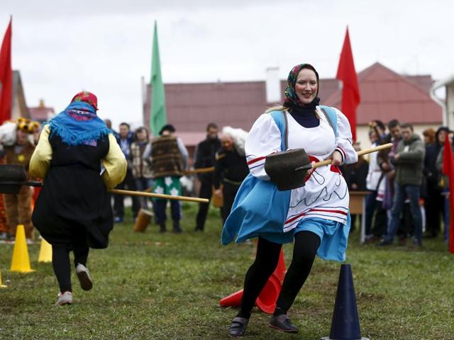 People play during the harvest festival in Dyatlovo, Belarus. (REUTERS)