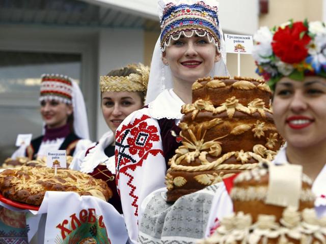 Dozhynki, the harvest festival of Belarus, marks the end of the harvesting in that nation. Women dressed in national clothes hold loaves as they wait for the participants of the regional harvest festival in the town of Dyatlovo, Belarus, November 13, 2015. (REUTERS)