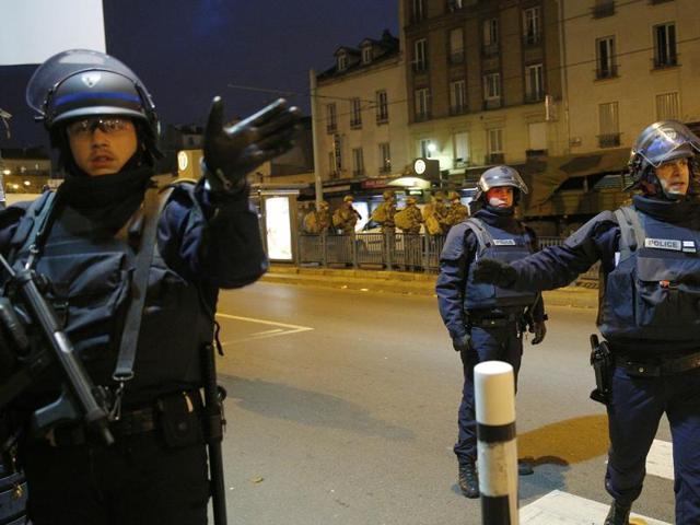 Police forces prepare in St. Denis, a northern suburb of Paris. Authorities in the Paris suburb of St. Denis were telling residents to stay inside during a large police operation near France's national stadium that two officials said was linked to last week's deadly attacks. (AP Photo)