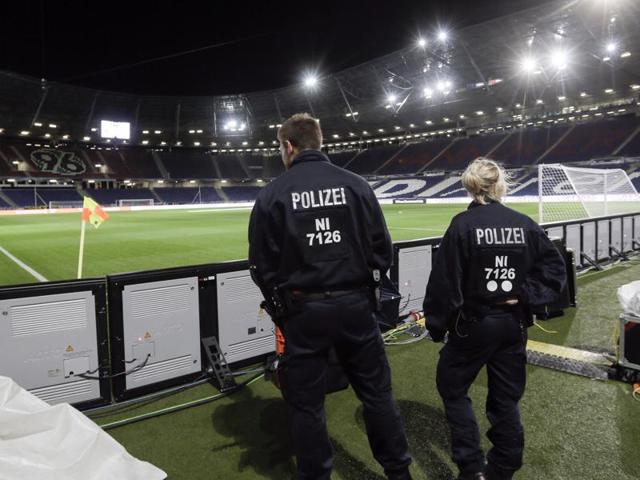 Two police officers stand in the stadium in Hanover, Germany after a friendly football match between Germany and the Netherlands was cancelled 90 minutes before kick-off on Tuesday due to the suspected threat of a bomb at the stadium.(AP Photo)