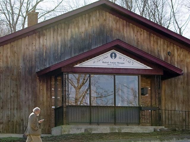 A member of the Ahmadiyya Muslim Community of Connecticut walks past the Baitul Aman mosque in South Meriden, Connecticut, where police and the FBI had been investigating reports of multiple gunshots fired at the mosque during the weekend. (AP Photo) A member of the Ahmadiyya Muslim Community of Connecticut walks past the Baitul Aman mosque in South Meriden, Connecticut, where police and the FBI had been investigating reports of multiple gunshots fired at the mosque during the weekend. (AP Photo)