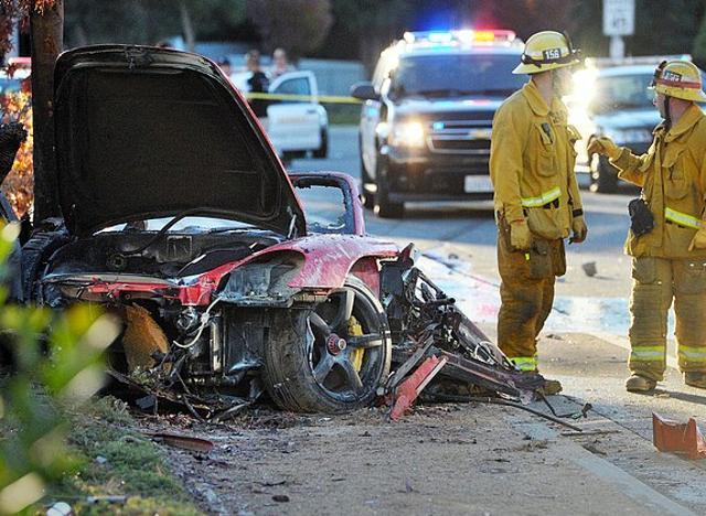 In this file photo, firefighters work next to the wreckage of a Porsche that crashed into a light pole killing actor Paul Walker and his friend Roger Rodas in Valencia, Calif. Crash investigators have determined that the Porsche was travelling approximately 90 mph when it lost control on a city street and smashed into a light pole, killing the actor and his friend. (AP) In this file photo, firefighters work next to the wreckage of a Porsche that crashed into a light pole killing actor Paul Walker and his friend Roger Rodas in Valencia, Calif. Crash investigators have determined that the Porsche was travelling approximately 90 mph when it lost control on a city street and smashed into a light pole, killing the actor and his friend. (AP)