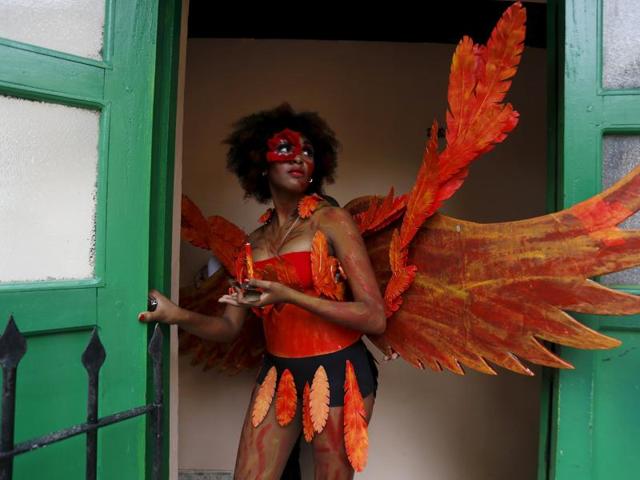 A student in orange prepares to do her bit in a school of theatre, makeup and hair styling graduation contest. (REUTERS)