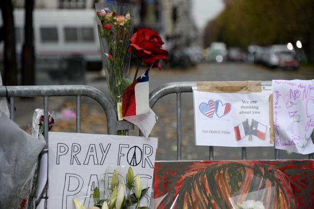 Floral tributes and messages lie at the police cordon in front of the Bataclan concert hall in Paris. (AFP) Floral tributes and messages lie at the police cordon in front of the Bataclan concert hall in Paris. (AFP)