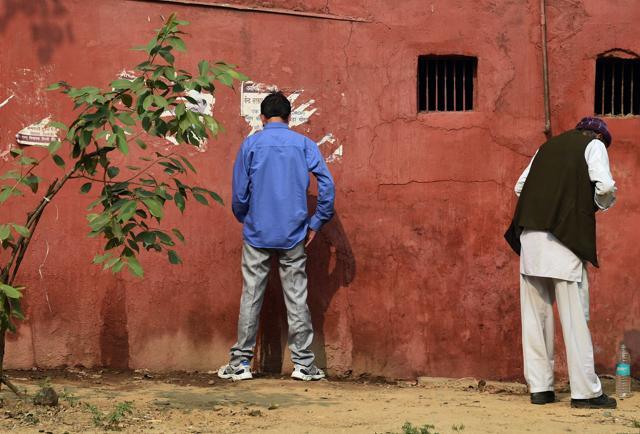Men urinate against a wall next to a road in New Delhi (AFP) Men urinate against a wall next to a road in New Delhi (AFP)