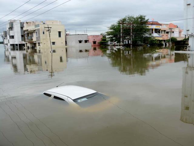 A car is submerged amidst water-logged houses in a rain-hit area of Chennai.(AFP) A car is submerged amidst water-logged houses in a rain-hit area of Chennai.(AFP)