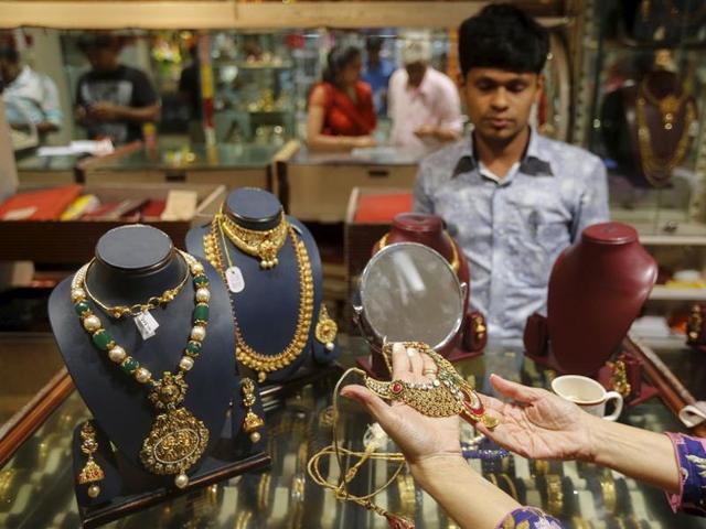 A customer tries a gold necklace at a jewellery showroom on the occasion of Dhanteras, a Hindu festival associated with Lakshmi, the goddess of wealth, at a market in Mumbai. (REUTERS) A customer tries a gold necklace at a jewellery showroom on the occasion of Dhanteras, a Hindu festival associated with Lakshmi, the goddess of wealth, at a market in Mumbai. (REUTERS)