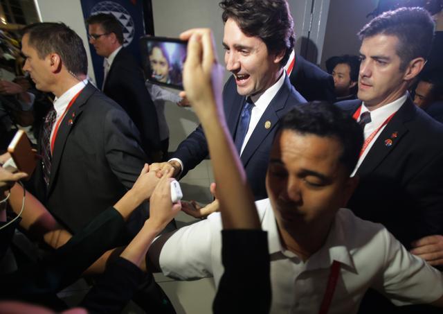 Canadian Prime Minister Justin Trudeau is surrounded by admirers as he leaves the International Media Centre following a press conference at the close of the Asia-Pacific Economic Cooperation (APEC) summit in Manila. (AP) Canadian Prime Minister Justin Trudeau is surrounded by admirers as he leaves the International Media Centre following a press conference at the close of the Asia-Pacific Economic Cooperation (APEC) summit in Manila. (AP)