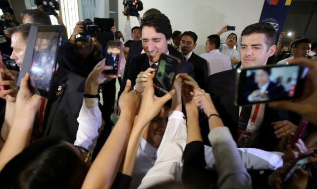 Canadian Prime Minister Justin Trudeau is surrounded by admirers as he leaves the International Media Centre following a press conference at the close of the Asia-Pacific Economic Cooperation (APEC) summit in Manila. (AP) Canadian Prime Minister Justin Trudeau is surrounded by admirers as he leaves the International Media Centre following a press conference at the close of the Asia-Pacific Economic Cooperation (APEC) summit in Manila. (AP)
