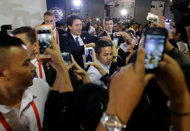 Canadian Prime Minister Justin Trudeau is surrounded by admirers as he leaves the International Media Centre following a press conference at the close of the Asia-Pacific Economic Cooperation (APEC) summit in Manila. (AP) Canadian Prime Minister Justin Trudeau is surrounded by admirers as he leaves the International Media Centre following a press conference at the close of the Asia-Pacific Economic Cooperation (APEC) summit in Manila. (AP)