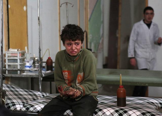 A wounded Syrian boy cries at a makeshift hospital following a reported air strike by government forces in the rebel-held area of Douma, east of the capital Damascus. (AFP) A wounded Syrian boy cries at a makeshift hospital following a reported air strike by government forces in the rebel-held area of Douma, east of the capital Damascus. (AFP)