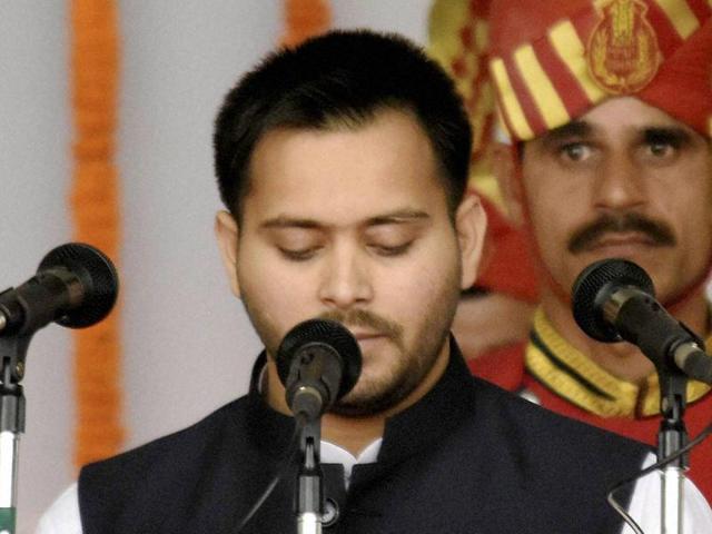 RJD chief Lalu Prasad's son Tejashwi Yadav takes oath as a minister during the swearing-in ceremony of the new government at Gandhi Maidan in Patna on Friday. (PTI Photo) RJD chief Lalu Prasad's son Tejashwi Yadav takes oath as a minister during the swearing-in ceremony of the new government at Gandhi Maidan in Patna on Friday. (PTI Photo)