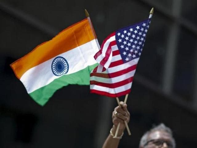 A man holds the flags of India and the US while people take part in the 35th India Day Parade in New York.(Reuters File Photo)