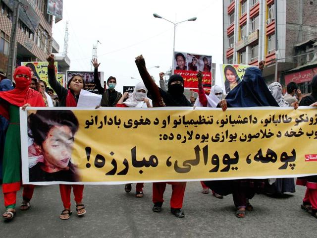 Women march as they hold photos showing ethnic Hazara victims who were allegedly beheaded by the Taliban, in Jalalabad, east of Kabul. (AP) Women march as they hold photos showing ethnic Hazara victims who were allegedly beheaded by the Taliban, in Jalalabad, east of Kabul. (AP)