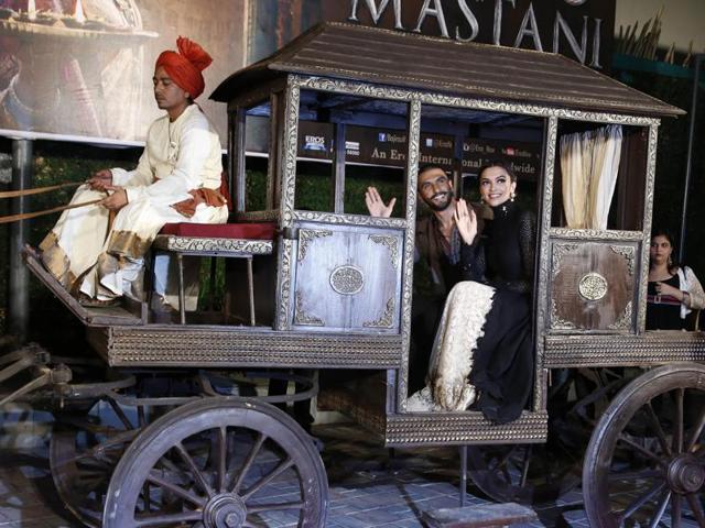 Ranveer Singh and Deepika Padukoneand their royal chariot at the trailer launch of Bajirao Mastani. (AP)