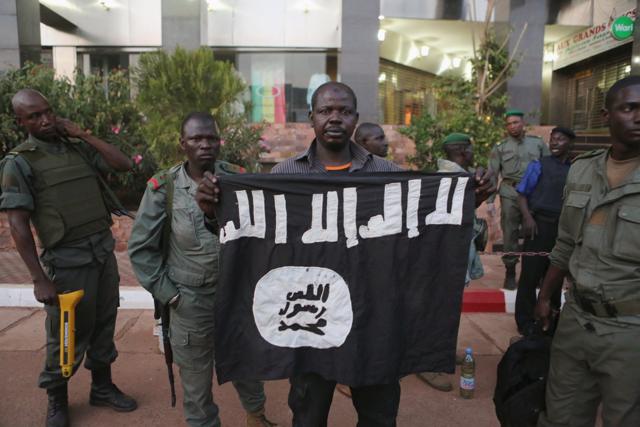 Malian security officials show a jihadist flag they said belonged to attackers in front of the Radisson hotel in Bamako. (REUTERS Photo) Malian security officials show a jihadist flag they said belonged to attackers in front of the Radisson hotel in Bamako. (REUTERS Photo)