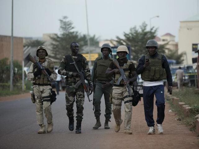 Malian soldiers walk in front of the Radisson hotel in Bamako, Mali. (REUTERS) Malian soldiers walk in front of the Radisson hotel in Bamako, Mali. (REUTERS)