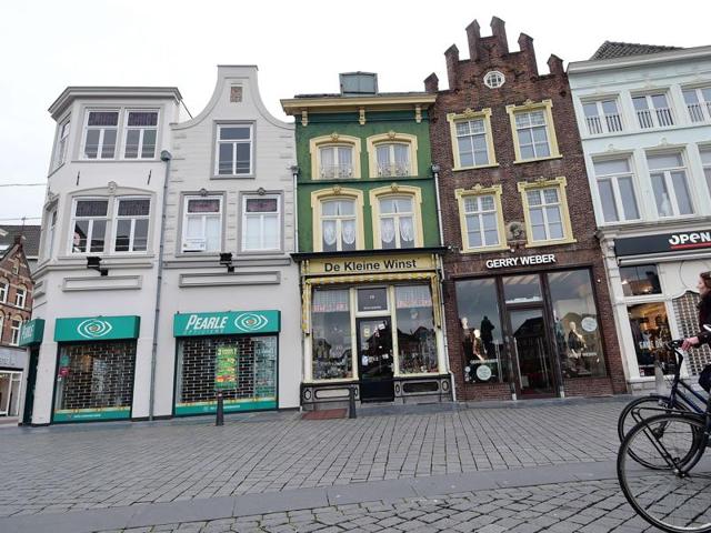 A small museum in his hometown has managed to bring together 20 of the last 25 known surviving panels by the painter often dubbed the ‘devil’s painter’ for the exhibition. People cycle past way past Bosch’s former workshop (in green). (AFP)