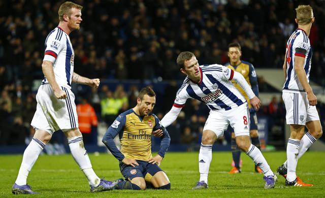 Santi Cazorla looks dejected after slipping and missing a penalty for Arsenal. (Reuters Photo)