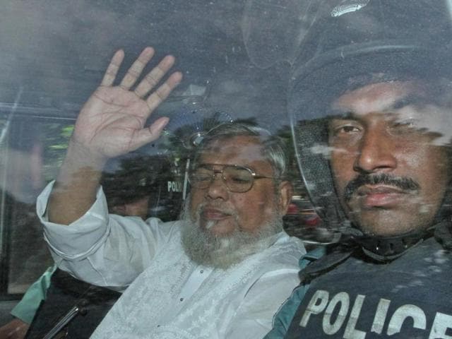 A file picture of Secretary General of Jamaat e Islam, Ali Ahsan Mohammad Mujahid (L) waving from a police vehicle as he is transported to the central jail after a court verdict in Dhaka. Bangladesh's highest court on November 18, 2015 upheld the death sentences of two opposition leaders, Ali Ahsan Mohammad Mujahid and Salahuddin Quader Chowdhury, convicted for atrocities during the 1971 war of independence against Pakistan.(AFP Photo)