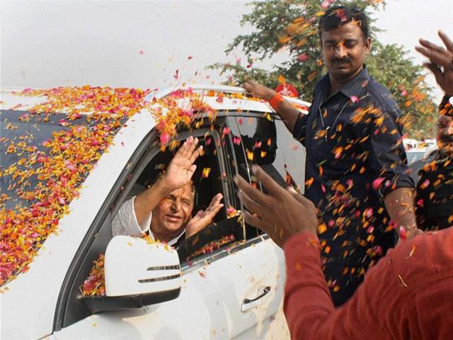 Supporters shower flowers on SP chief Mulayam Singh Yadav as he arrives at a programme to celebrate his 77th birthday in Saifai on Saturday. (PTI Photo)