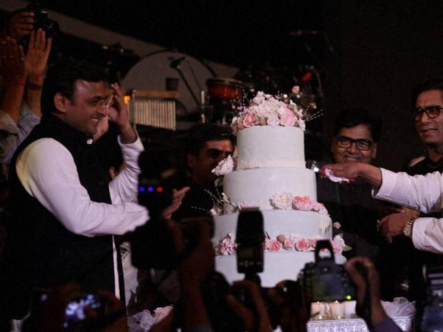 Samajwadi Party supremo Mulayam Singh Yadav with Uttar Pradesh Chief Minister Akhilesh Yadav cutting cake on the occasion of his 77th birthday in Saifai on Saturday. (PTI Photo)
