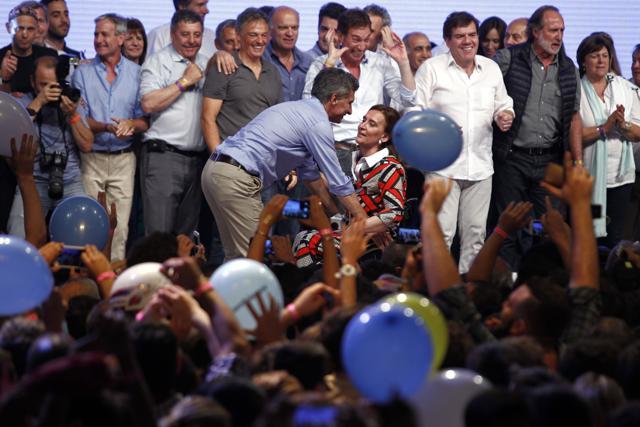 Mauricio Macri (C) celebrates with his running mate Gabriela Michetti (C-R) at the Cambiemos (Let's Change) party headquarters in Buenos Aires after getting early results of the presidential run-off election in Argentina. (AFP photo) Mauricio Macri (C) celebrates with his running mate Gabriela Michetti (C-R) at the Cambiemos (Let's Change) party headquarters in Buenos Aires after getting early results of the presidential run-off election in Argentina. (AFP photo)