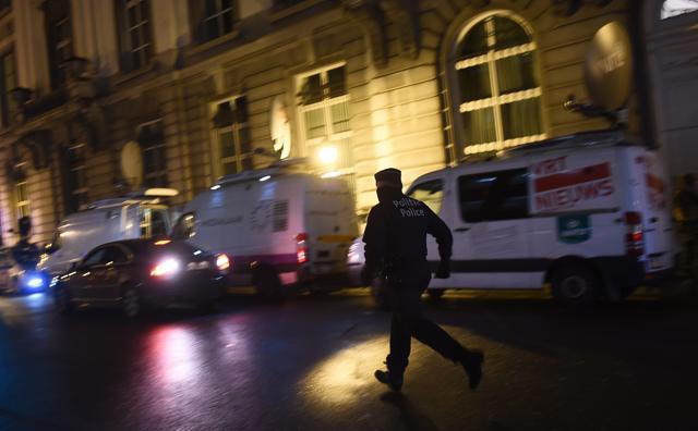 A policeman runs as security forces secure an area during a press conference by the Belgian Prime Minister concerning the country's security alert level in Brussels. (AFP) A policeman runs as security forces secure an area during a press conference by the Belgian Prime Minister concerning the country's security alert level in Brussels. (AFP)