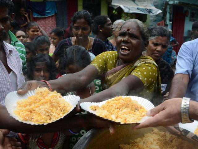 People collect food from a distribution point after flooding in Chennai. Large areas of the city have been flooded following days of heavy rain.(AFP Photo) People collect food from a distribution point after flooding in Chennai. Large areas of the city have been flooded following days of heavy rain.(AFP Photo)