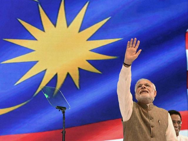 Prime Minister Narendra Modi waves to the Indian community during an event in Kuala Lumpur. (PTI) Prime Minister Narendra Modi waves to the Indian community during an event in Kuala Lumpur. (PTI)