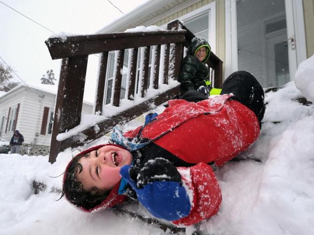 Luca Damato of Wisconsin slides down packed snow on his stairs as another child looks on while they play outside their home, Nov. 21, 2015. The first significant snowstorm of the season blanketed some parts of the Midwest in the US with more than a foot of snow causing hazardous travel conditions and flight delays. (Sean Krajacic/The Kenosha News) (AP) Luca Damato of Wisconsin slides down packed snow on his stairs as another child looks on while they play outside their home, Nov. 21, 2015. The first significant snowstorm of the season blanketed some parts of the Midwest in the US with more than a foot of snow causing hazardous travel conditions and flight delays. (Sean Krajacic/The Kenosha News) (AP)