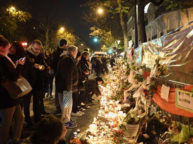 People gather at a makeshift memorial in tribute to the victims of a series of deadly attacks in Paris. (AFP) People gather at a makeshift memorial in tribute to the victims of a series of deadly attacks in Paris. (AFP)
