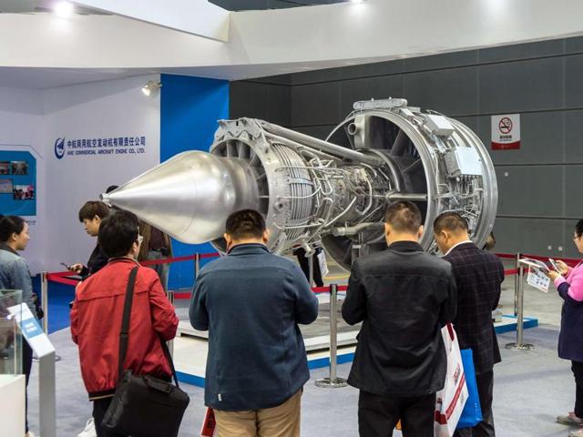 This picture shows visitors taking photos of an aircraft engine at the 17th China International Industry Fair (CIIF) in Shanghai. (AFP) This picture shows visitors taking photos of an aircraft engine at the 17th China International Industry Fair (CIIF) in Shanghai. (AFP)