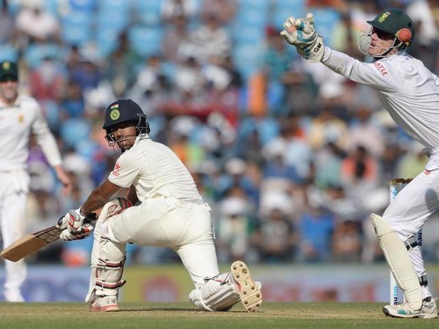 India's Wriddhiman Saha looks back after playing a shot as Dane Vilas attempts to catch the ball. (AFP Photo) India's Wriddhiman Saha looks back after playing a shot as Dane Vilas attempts to catch the ball. (AFP Photo)