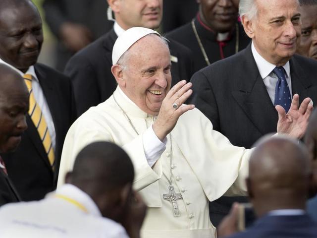 Pope Francis greets traditional dancers on his arrival at the airport in Nairobi, Kenya.(AP)