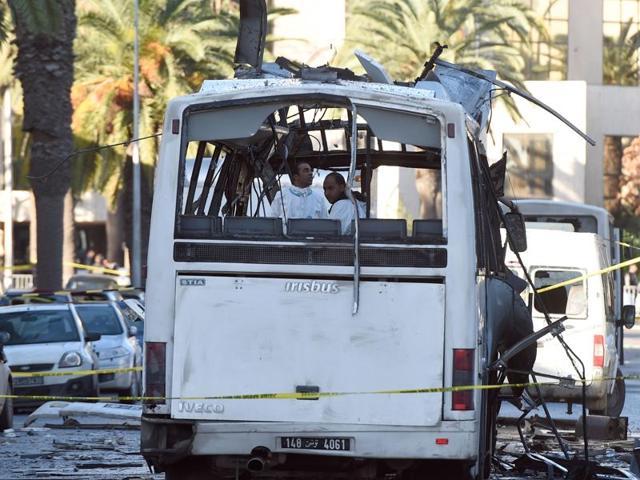 Tunisian forensic police inspect the wreckage of a bus in the aftermath of a bomb attack on the vehicle which was transporting Tunisia's presidential guard in central Tunis on November 25, 2015.(AFP) Tunisian forensic police inspect the wreckage of a bus in the aftermath of a bomb attack on the vehicle which was transporting Tunisia's presidential guard in central Tunis on November 25, 2015.(AFP)