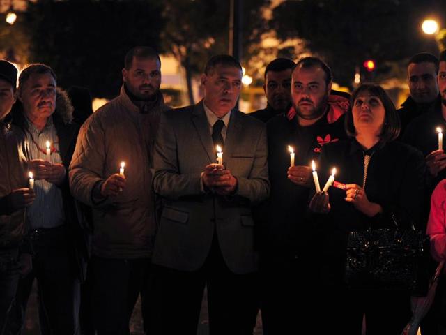 Tunisian Nidaa Tounes party members hold candles during a vigil in Tunis in memory of the victims of a bomb blast earlier in the day on a bus transporting Tunisia's presidential guard in the centre of Tunis. (AFP) Tunisian Nidaa Tounes party members hold candles during a vigil in Tunis in memory of the victims of a bomb blast earlier in the day on a bus transporting Tunisia's presidential guard in the centre of Tunis. (AFP)